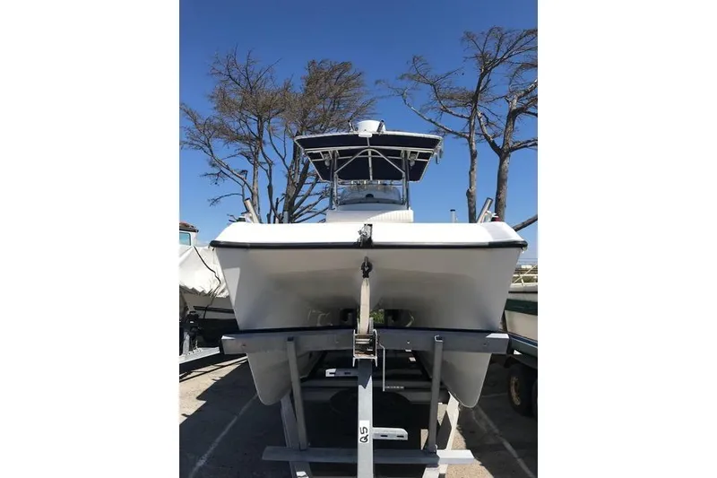 Slide: The Image of 2005 Glacier Bay 260 Canyon Runner boat on trailer, clear sky background. - 6
