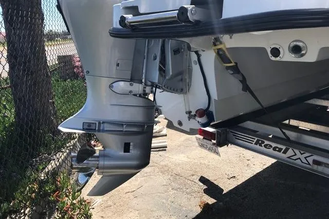 Slide: The Image of 2005 Glacier Bay 260 Canyon Runner boat on trailer, showing outboard motor and propeller. - 7