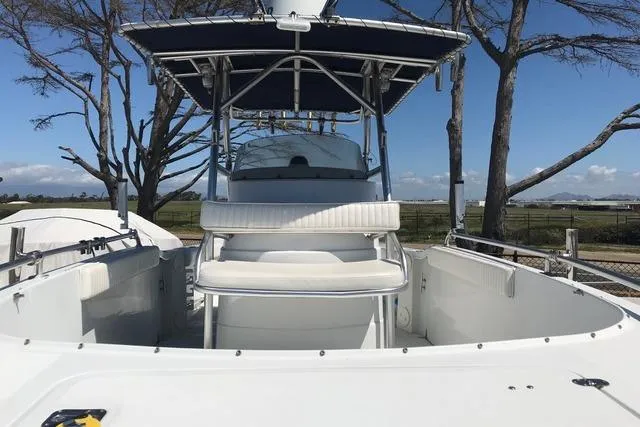 Slide: The Image of 2005 Glacier Bay 260 Canyon Runner boat with T-top and seating, docked outdoors. - 8