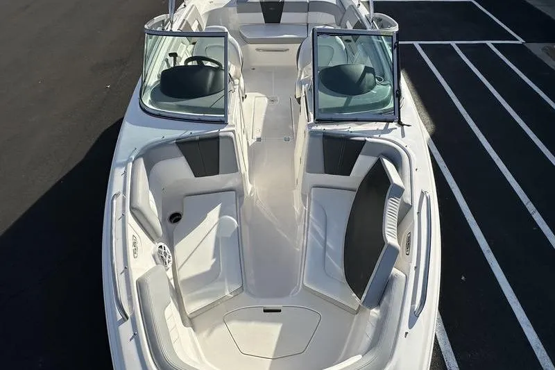 Slide: The Image of 2022 Chaparral 23 SSi OB boat interior with open bow seating and dual consoles. - 14
