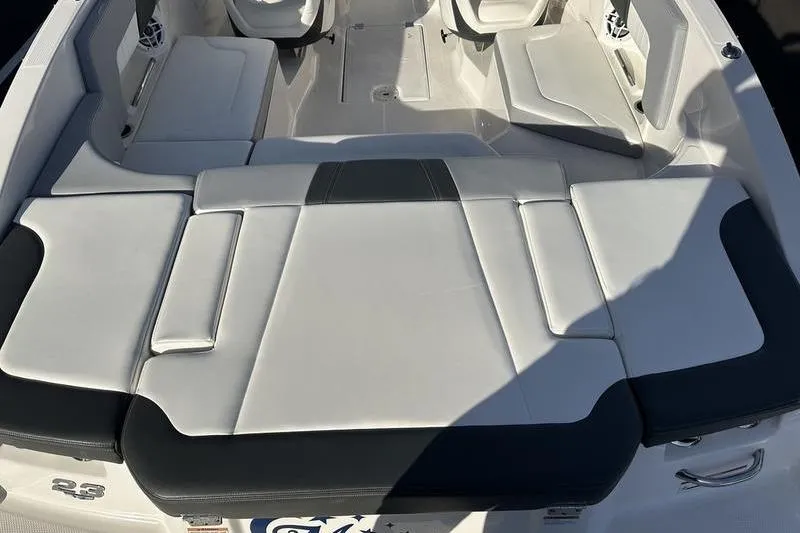 Slide: The Image of 2022 Chaparral 23 SSi OB boat interior with white cushioned seating. - 15