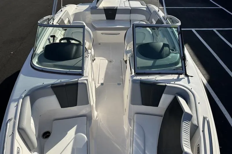Slide: The Image of 2022 Chaparral 23 SSi OB boat interior with open seating and dual consoles. - 16