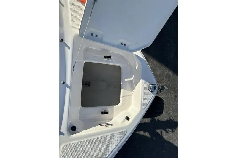 Slide: The Image of Open storage compartment on 2022 Chaparral 23 SSi OB boat deck. - 18