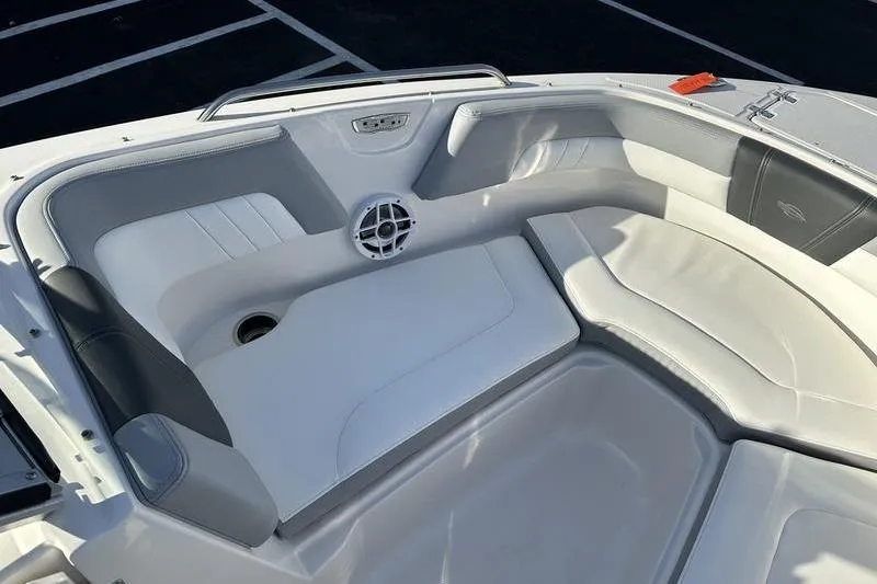 Slide: The Image of 2022 Chaparral 23 SSi OB boat interior with white cushioned seating and speaker. - 20