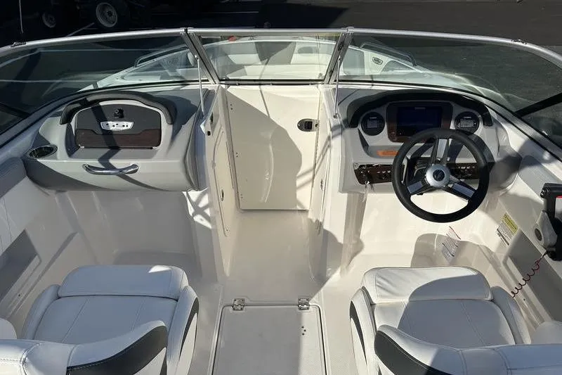 Slide: The Image of 2022 Chaparral 23 SSi OB boat interior with steering wheel and seating. - 22