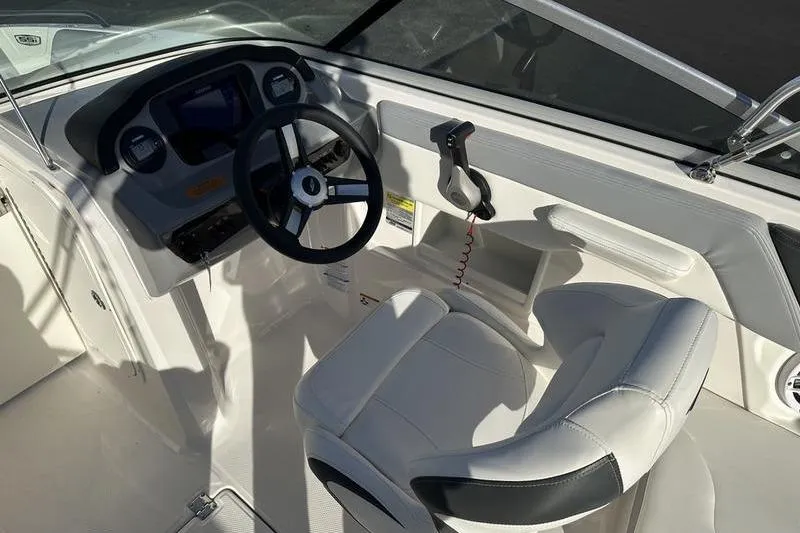 Slide: The Image of 2022 Chaparral 23 SSi OB boat cockpit with steering wheel and captain's chair. - 26