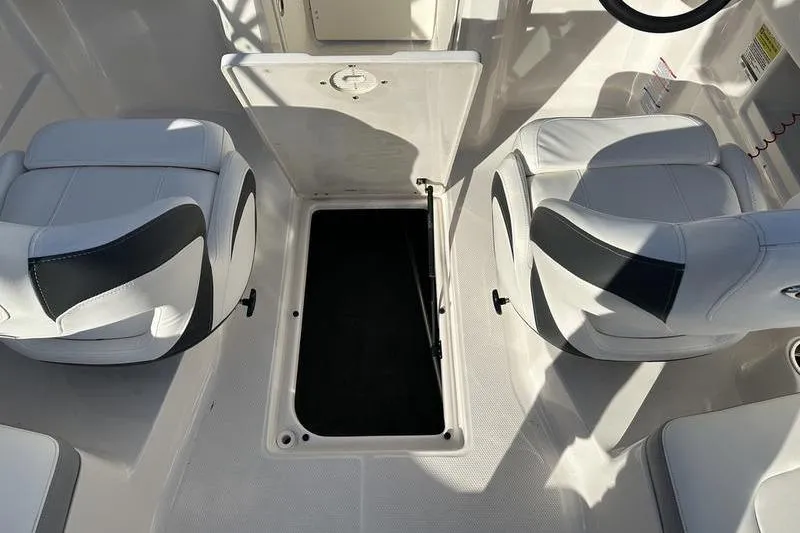 Slide: The Image of 2022 Chaparral 23 SSi OB boat interior with open storage compartment and seating. - 27