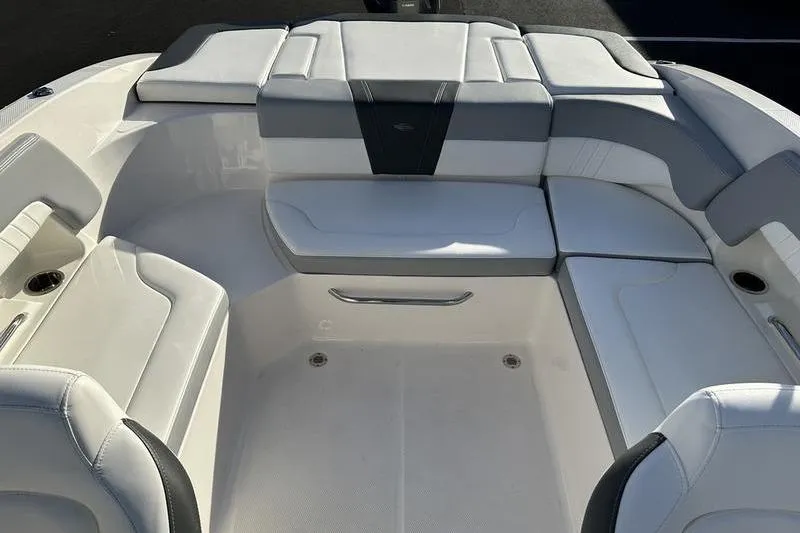 Slide: The Image of 2022 Chaparral 23 SSi OB boat interior with white and gray seating. - 35