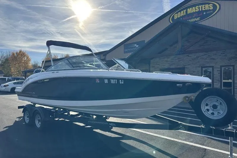 Slide: The Image of 2022 Chaparral 23 SSi OB boat on trailer at dealership, sunny day. - 4