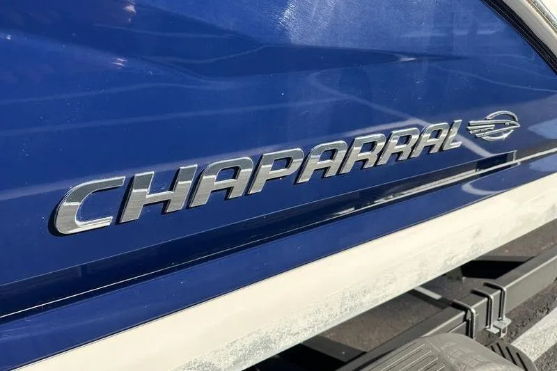 Slide: The Image of 2022 Chaparral 23 SSi OB boat, blue exterior with chrome logo detail. - 5