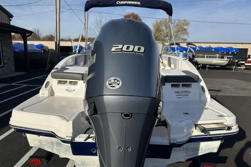 Slide: The Image of 2022 Chaparral 23 SSi OB boat with Yamaha 200 outboard motor, parked outdoors. - 9