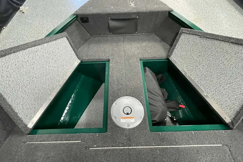Slide: The Image of 2025 Lund 1650 Angler Tiller boat interior with open storage compartments. - 11
