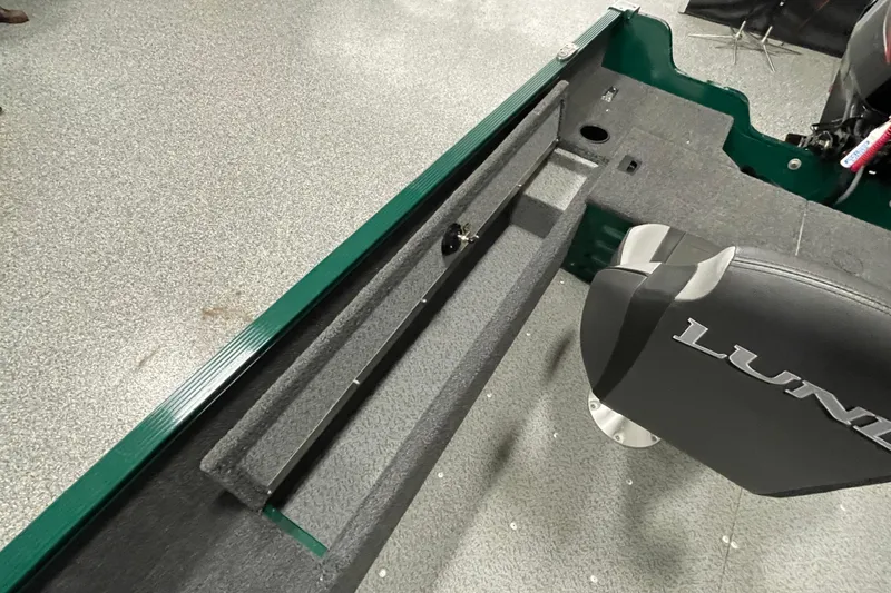 Slide: The Image of 2025 Lund 1650 Angler Tiller boat interior with seating and storage features. - 13