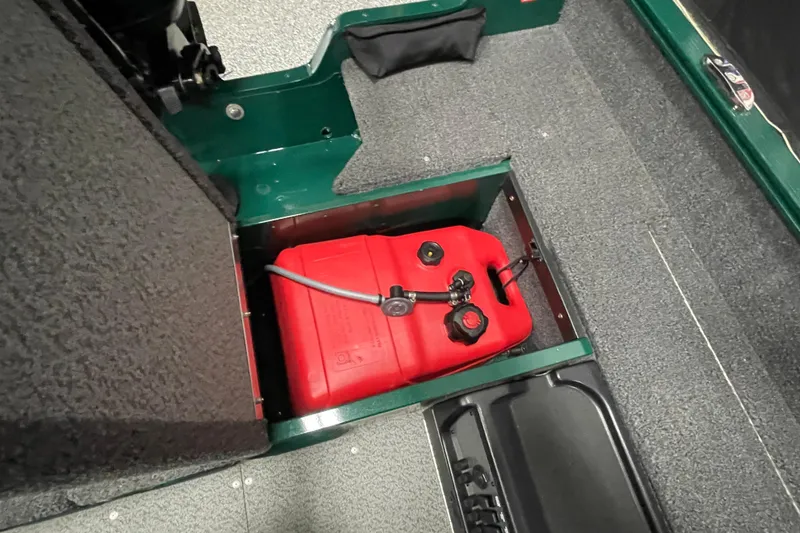 Slide: The Image of 2025 Lund 1650 Angler Tiller boat with red fuel tank in storage compartment. - 15