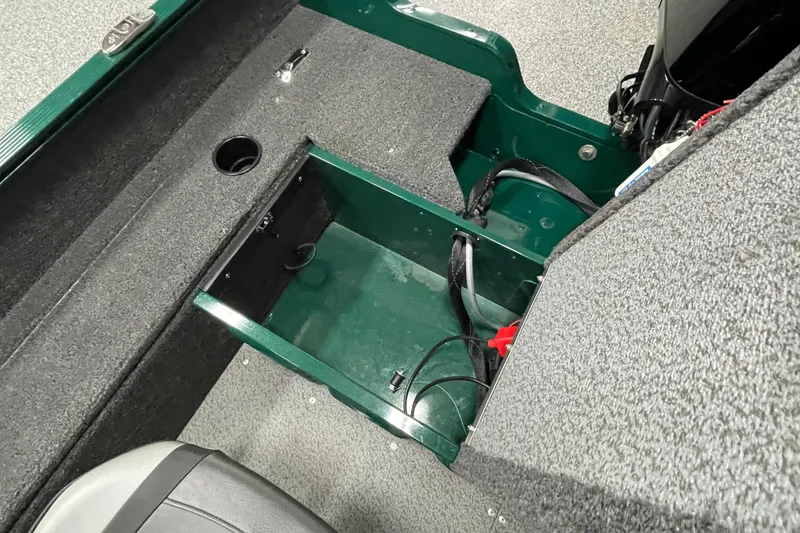 Slide: The Image of 2025 Lund 1650 Angler Tiller interior storage compartment with carpeted finish and wiring. - 16