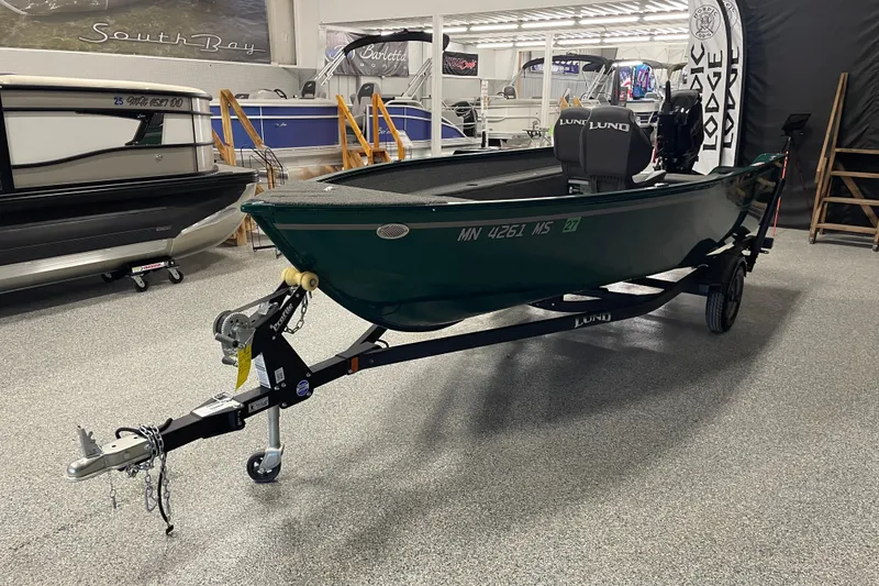 Slide: The Image of 2025 Lund 1650 Angler Tiller boat on trailer in showroom. - 2