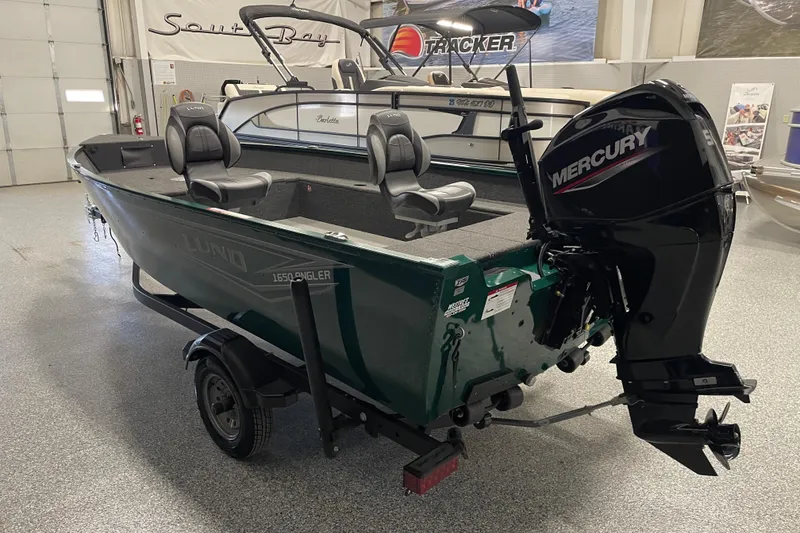 Slide: The Image of 2025 Lund 1650 Angler Tiller boat with Mercury outboard motor in showroom. - 4