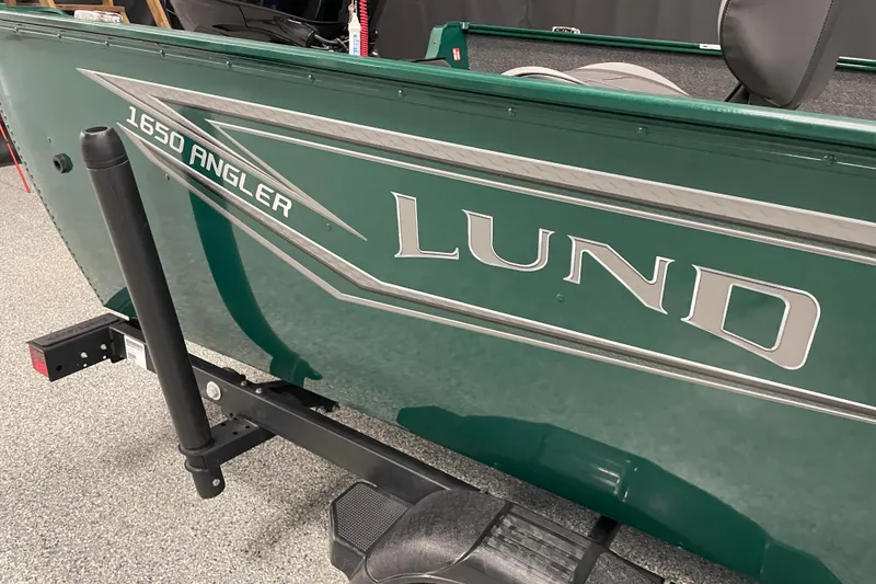 Slide: The Image of 2025 Lund 1650 Angler Tiller boat, green exterior, side view. - 6
