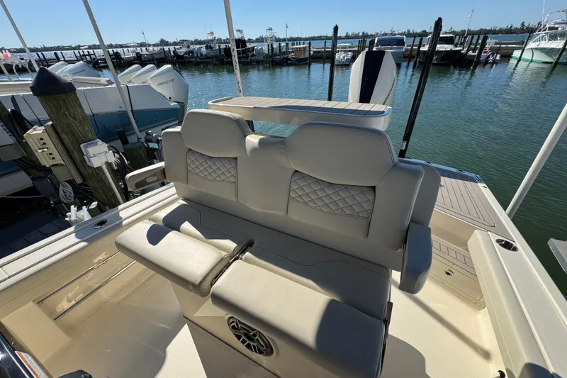 Slide: The Image of Luxury seating on 2025 Scout 281 XSS boat docked at marina. - 18