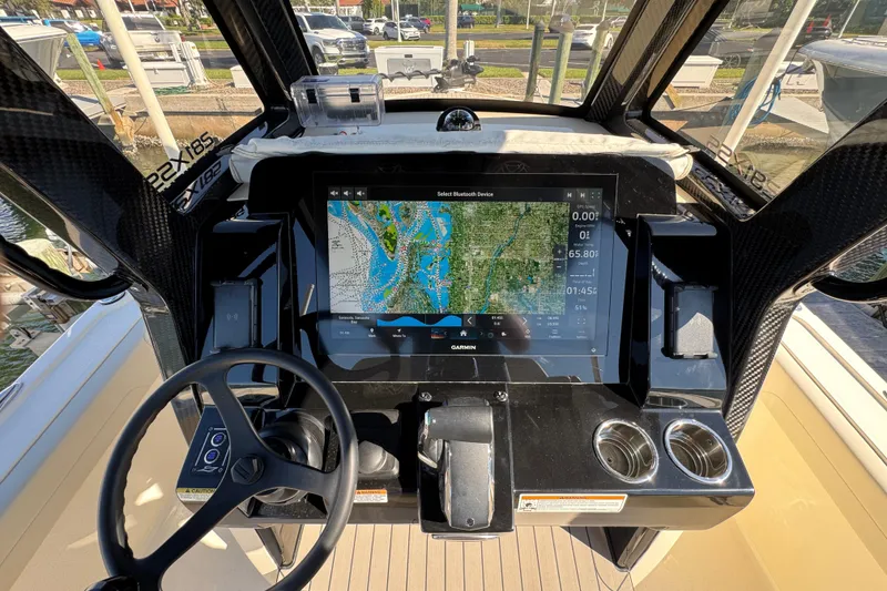 Slide: The Image of 2025 Scout 281 XSS boat dashboard with Garmin navigation display and steering wheel. - 22