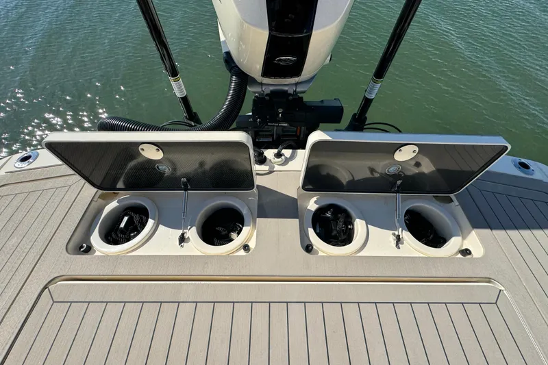 Slide: The Image of 2025 Scout 281 XSS boat deck with open storage compartments. - 30