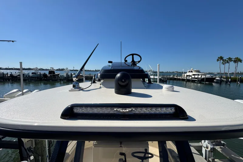 Slide: The Image of 2025 Scout 281 XSS boat docked at marina under clear blue sky. - 33