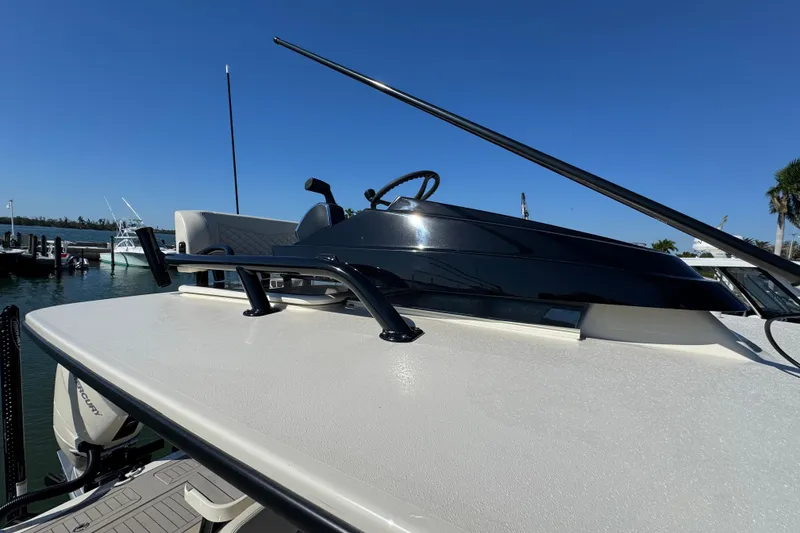 Slide: The Image of 2025 Scout 281 XSS boat with sleek design, docked under clear blue sky. - 34