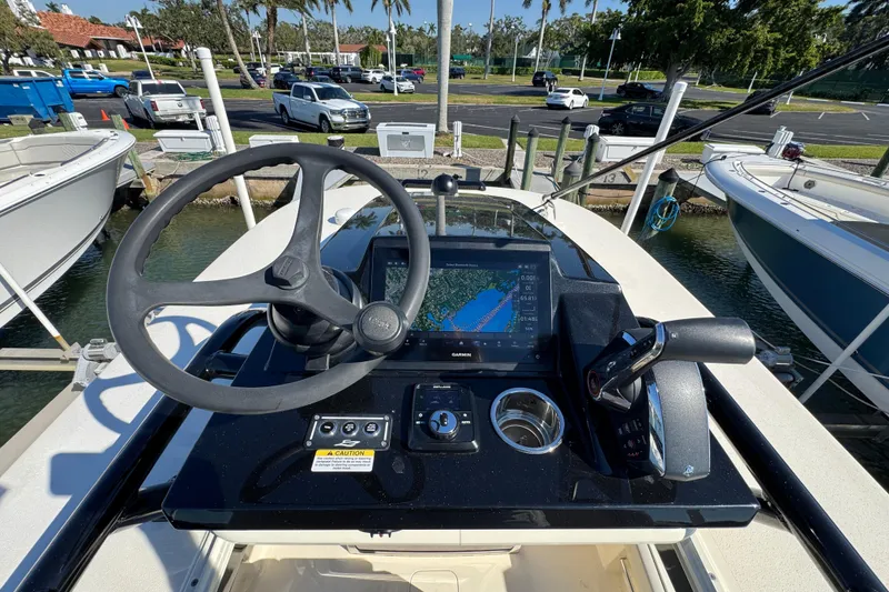 Slide: The Image of 2025 Scout 281 XSS boat helm with steering wheel and navigation display. - 35