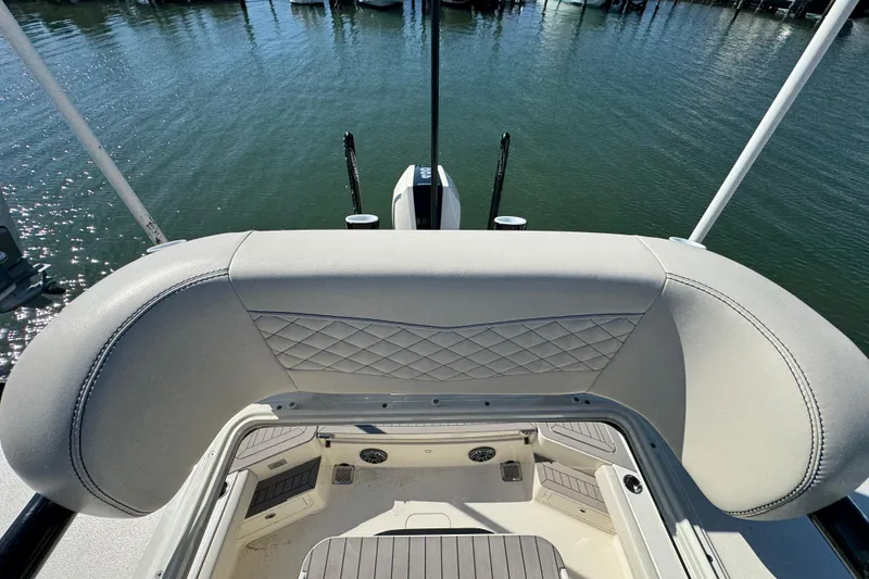 Slide: The Image of 2025 Scout 281 XSS boat interior with cushioned seating and water view. - 36