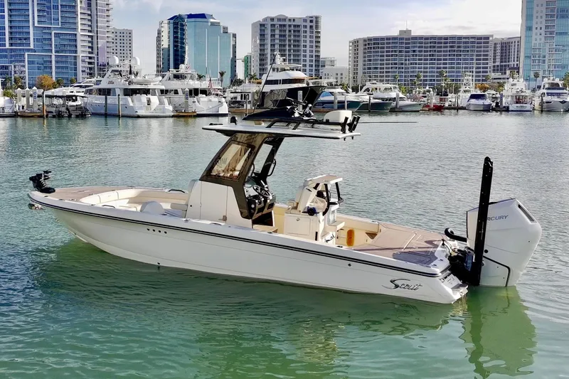 Slide: The Image of 2025 Scout 281 XSS boat docked in marina with city skyline background. - 40