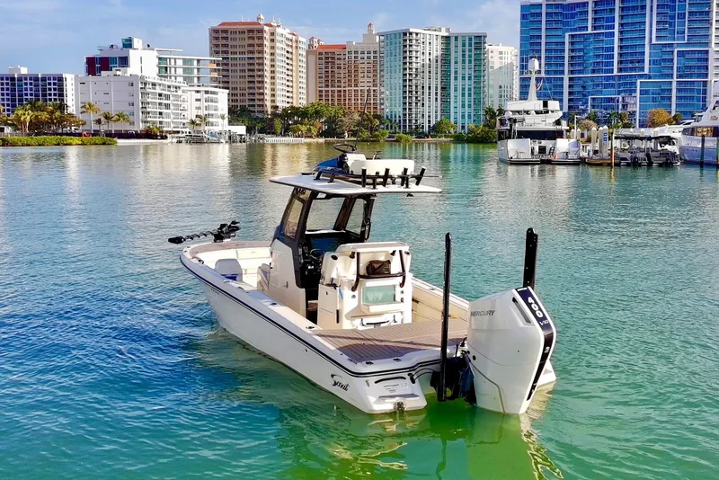 Slide: The Image of 2025 Scout 281 XSS boat on calm water with city skyline background. - 42