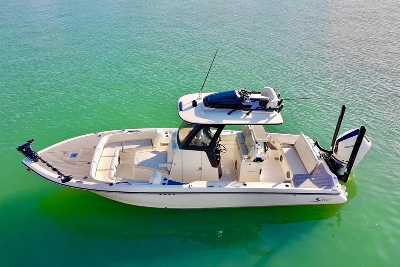 Slide: The Image of 2025 Scout 281 XSS boat on clear turquoise water, aerial view. - 43