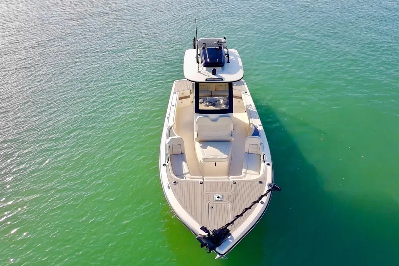 Slide: The Image of 2025 Scout 281 XSS boat on calm green water, aerial view. - 46