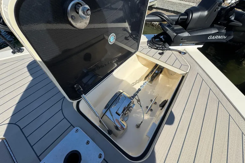 Slide: The Image of Open anchor compartment on 2025 Scout 281 XSS boat with Garmin equipment. - 5