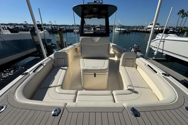 Slide: The Image of 2025 Scout 281 XSS boat interior with spacious seating at marina dock. - 9