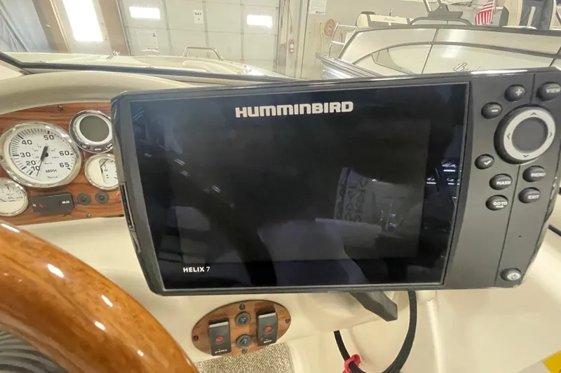 Slide: The Image of Dashboard of a 2010 Glastron GT 185 boat with gauges and controls. - 12