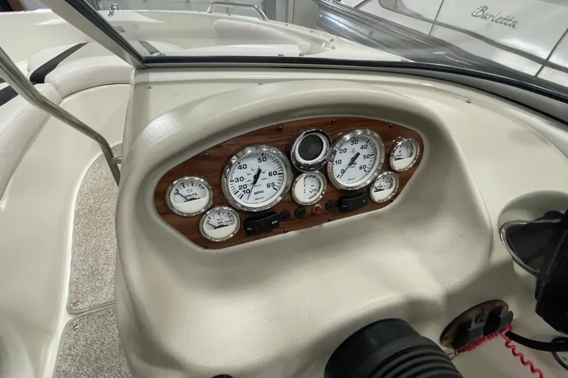 Slide: The Image of 2010 Glastron GT 185 boat dashboard with storage compartment and radio. - 13