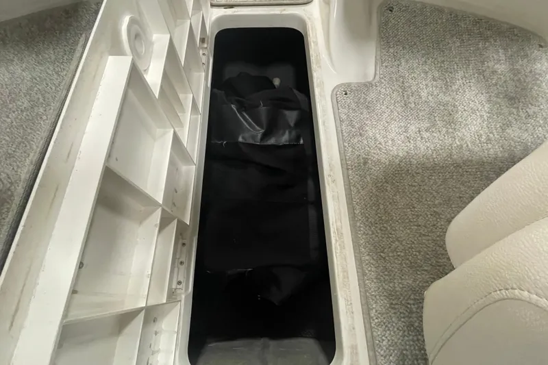 Slide: The Image of 2010 Glastron GT 185 boat interior with white seating and cup holders. - 15