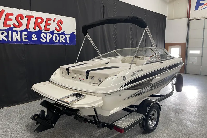 Slide: The Image of 2010 Glastron GT 185 boat displayed indoors on a trailer. - 3