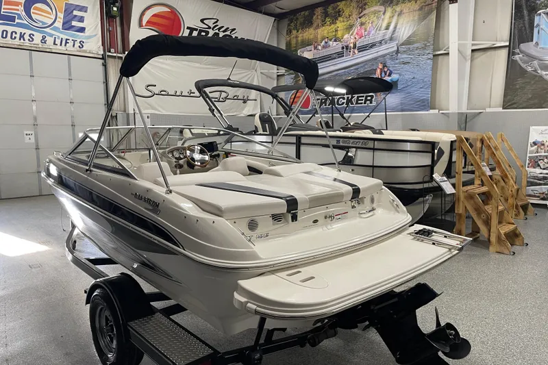 Slide: The Image of 2010 Glastron GT 185 boat with MerCruiser outdrive in a showroom. - 4