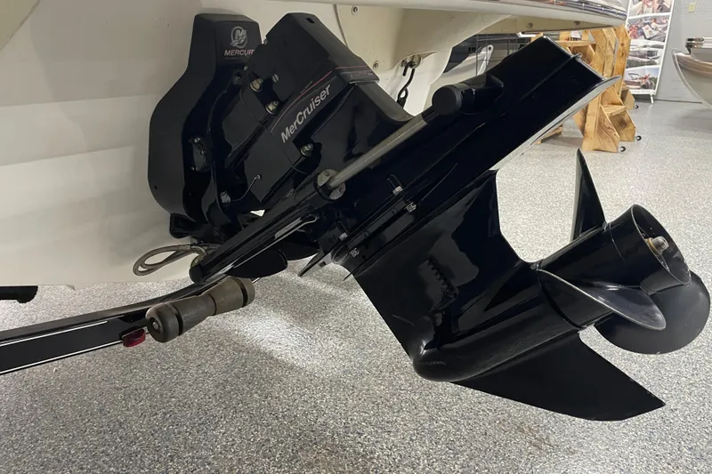 Slide: The Image of 2010 Glastron GT 185 boat interior with white seating and black accents in a showroom. - 5