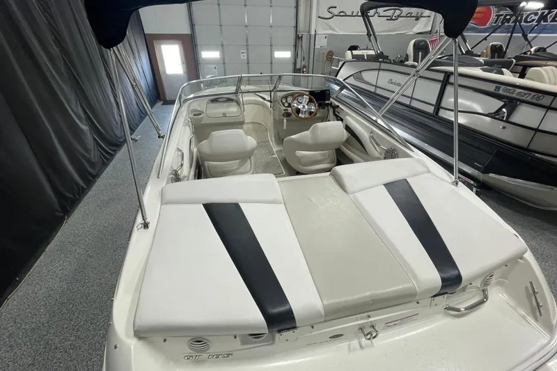 Slide: The Image of 2010 Glastron GT 185 boat interior with sleek seating in a showroom. - 6