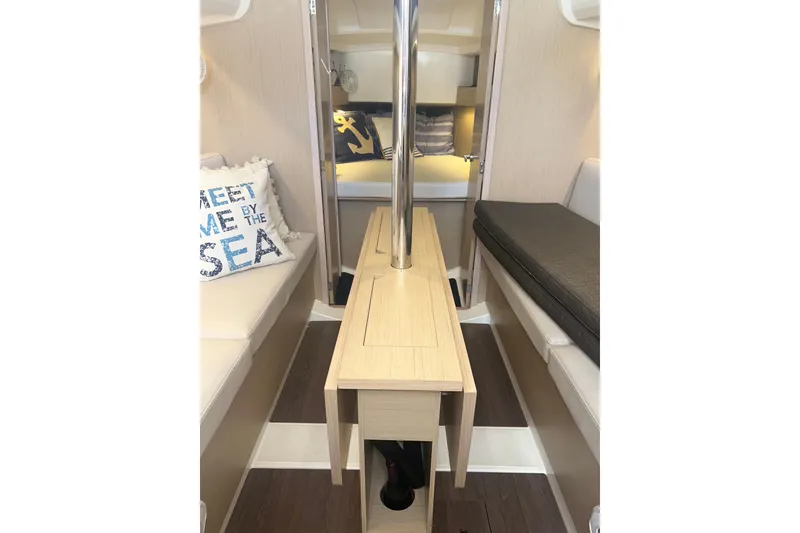 Slide: The Image of Interior of 2020 Beneteau Oceanis 30.1 sailboat with cozy seating and nautical decor. - 10