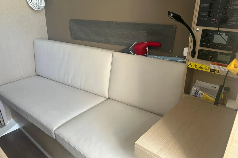 Slide: The Image of Interior of 2020 Beneteau Oceanis 30.1 yacht with white seating and control panel. - 3