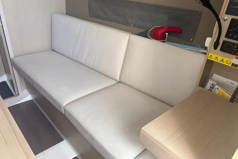 Slide: The Image of Interior of 2020 Beneteau Oceanis 30.1 yacht with white seating and control panel. - 4