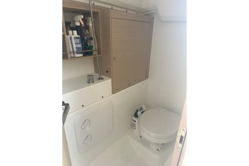 Slide: The Image of Beneteau Oceanis 30.1 2020 yacht bathroom with toilet and storage cabinet. - 6