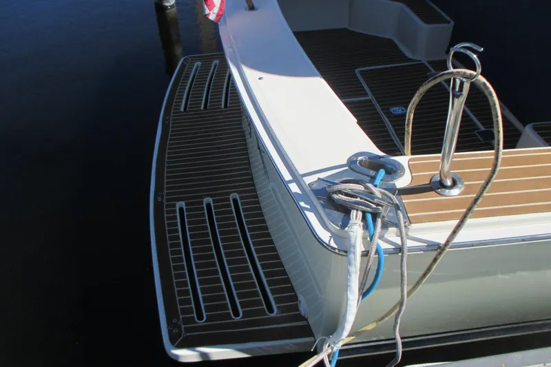 Slide: The Image of 2005 Mainship Pilot 34 Sedan boat stern with deck and mooring ropes. - 11