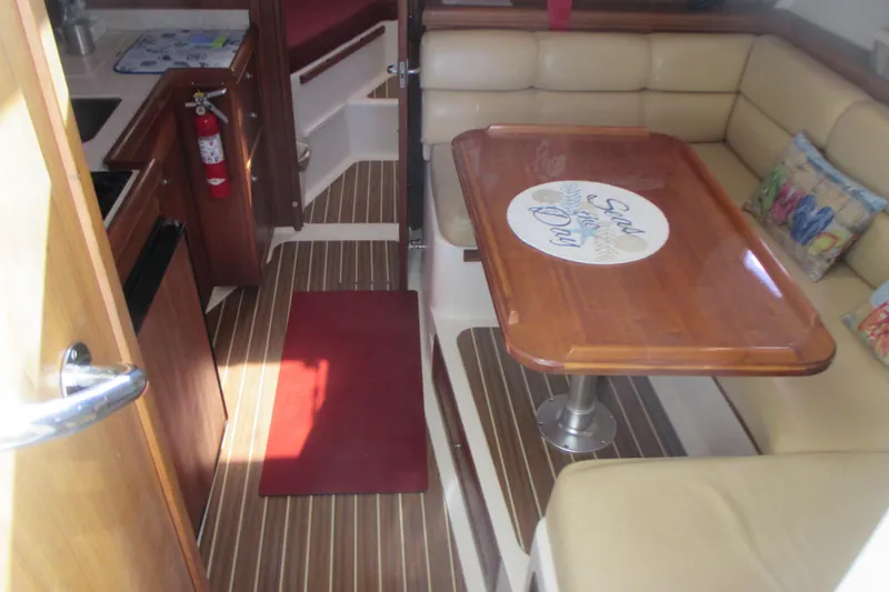 Slide: The Image of 2005 Mainship Pilot 34 Sedan interior with dining area and kitchenette. - 23