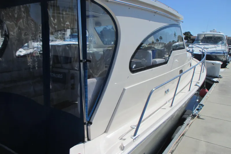 Slide: The Image of 2005 Mainship Pilot 34 Sedan docked at marina, side view. - 5