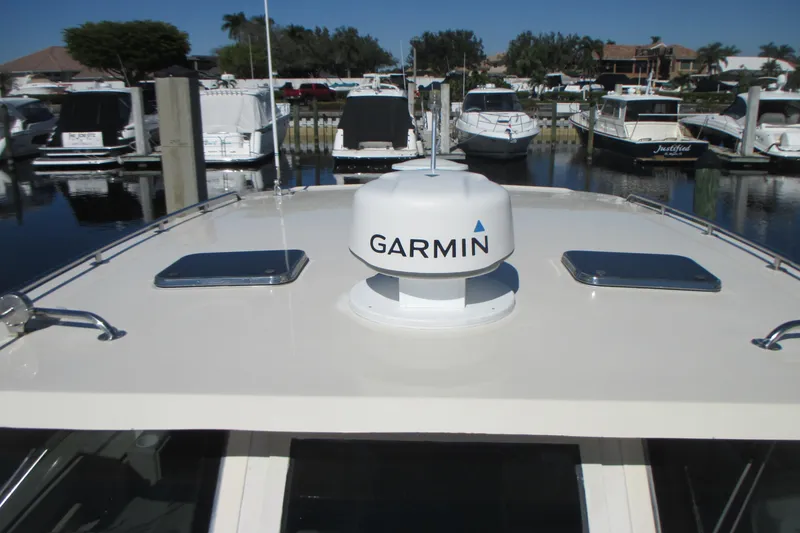 Slide: The Image of 2005 Mainship Pilot 34 Sedan with Garmin radar, docked in a marina. - 8